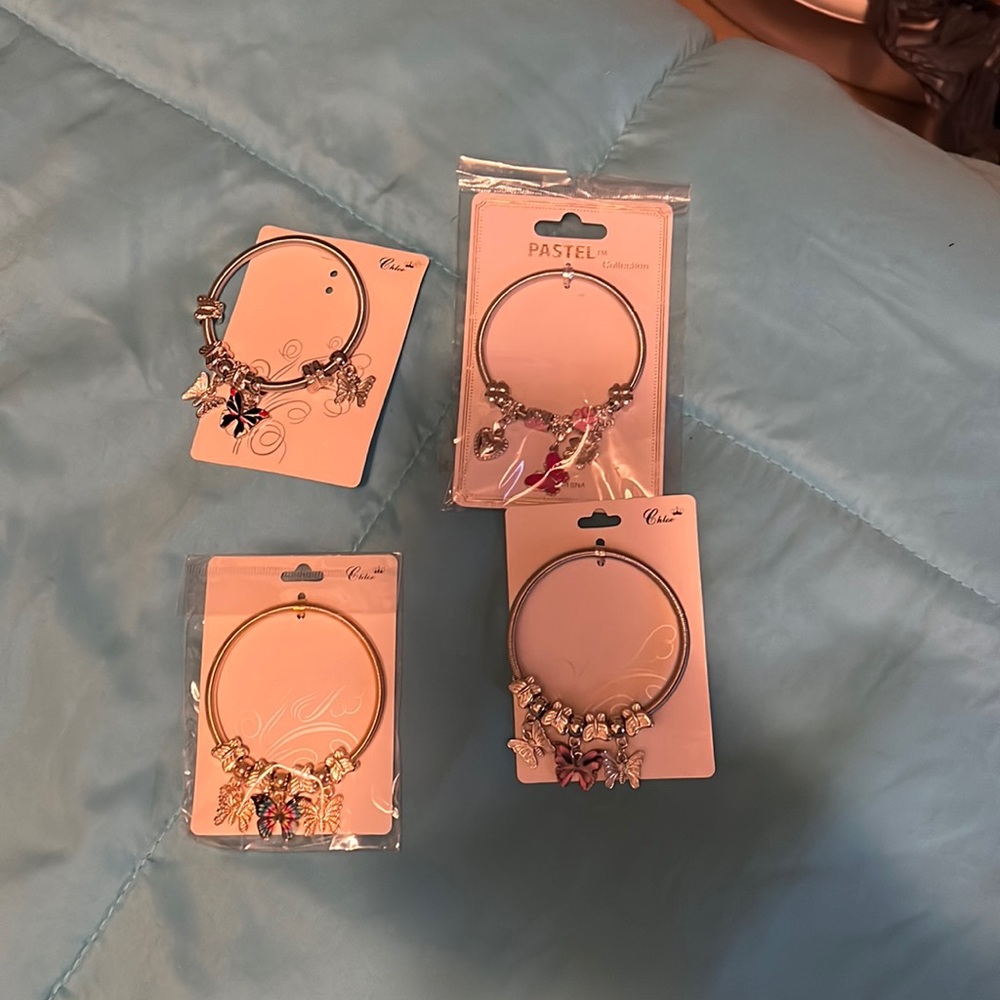 Set of. 4 beautiful butterfly coil bracelets.  3 are silvertone and one goldtone